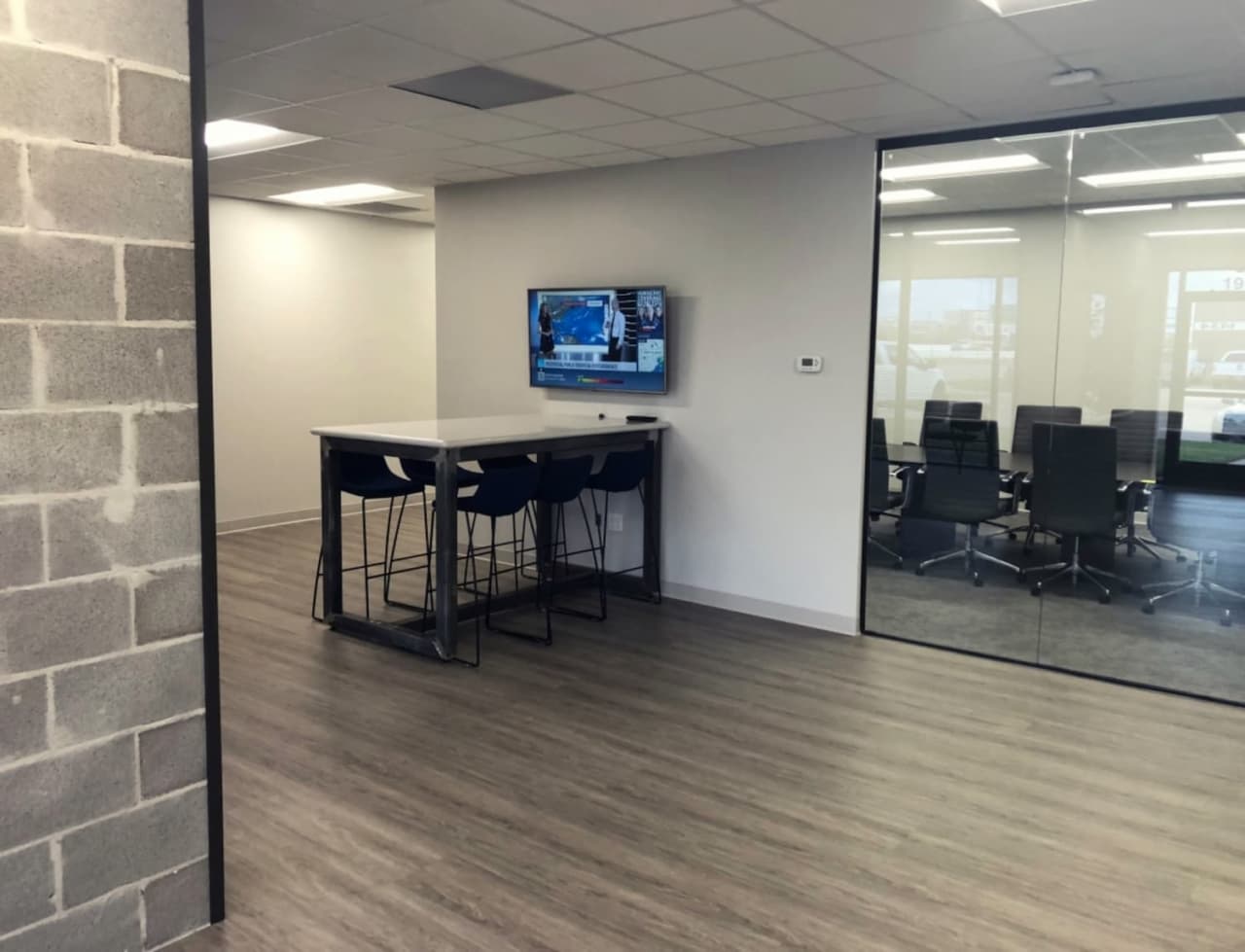 Sealy & Co reception with backlit signage and walnut paneling