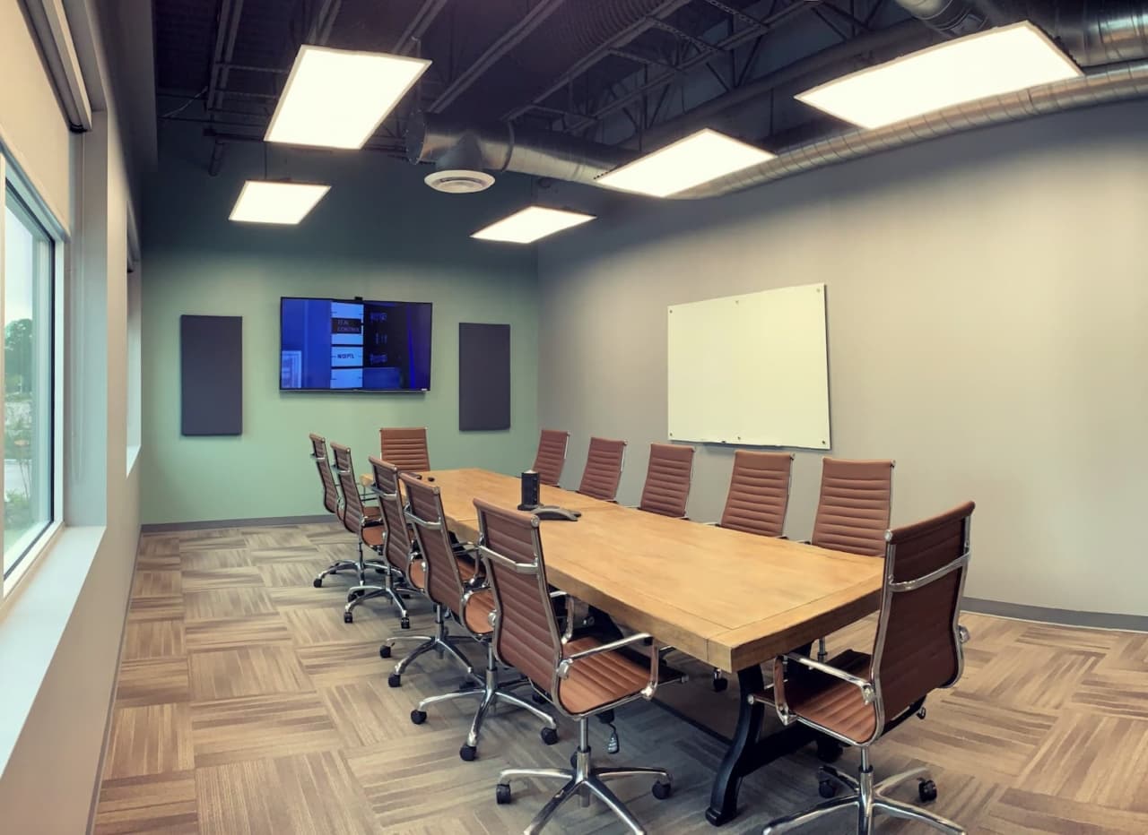 Willbanks conference room with large display and stone wall